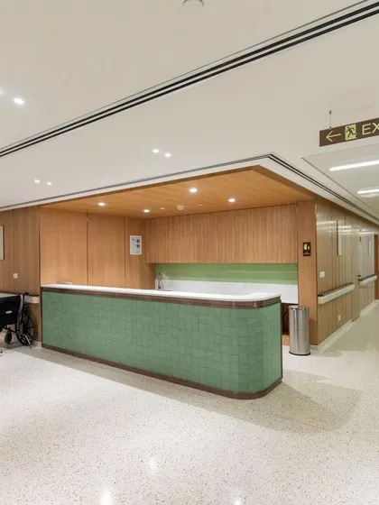 The nursing station and corridor at Breach Candy Hospital are designed for functionality and aesthetic appeal. The green-tiled desk adds a soothing color, while the wide, well-lit hallway ensures easy accessibility for wheelchairs and staff.