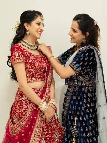 A sweet moment between me and the bride. I am making sure every detail, like her necklace, is perfectly in place before she makes her entrance.