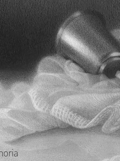 A detail of the soft cloth and the tilted glass.