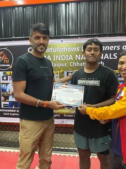 Presenting a certificate of achievement to one of our national medalists. We are proud to recognize the hard work and success of our athletes.
