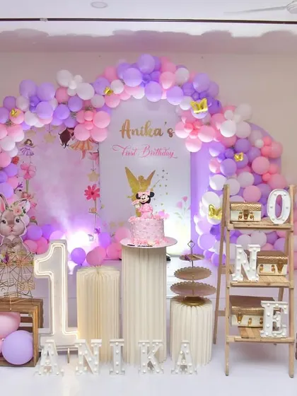 A closer look at the fairy tale theme, this setup includes a beautiful balloon arch, light-up marquee letters for the baby's name and age, and rustic wooden crates for a charming, woodland feel.