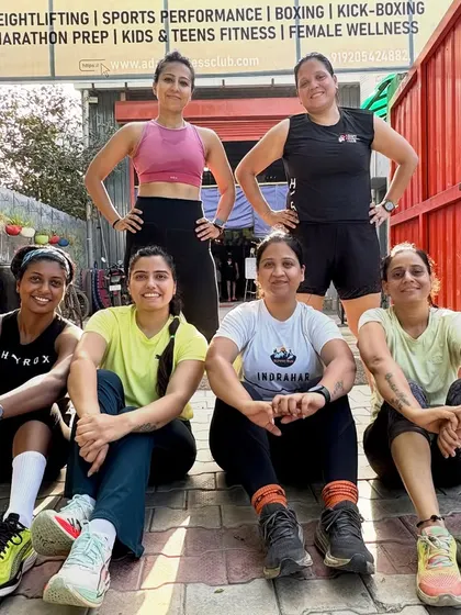 The women of our AFC squad, sitting together after a challenging community workout. The camaraderie here is just as important as the training.