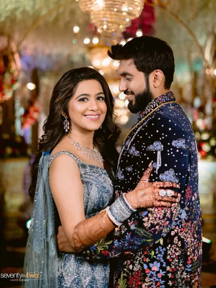 Your reception look is a chance to shine. For this glamorous evening event, we chose a sophisticated makeup style with soft waves that complemented her stunning modern blue lehenga, creating a look that was both chic and celebratory.