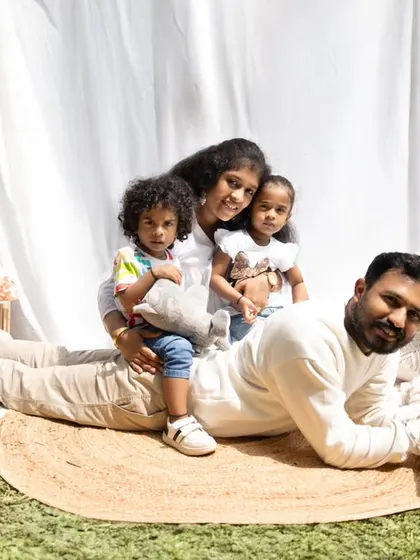 A duplicate of image 140, this playful outdoor shot captures the fun and loving chaos of family life as the kids pile onto their dad.