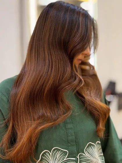Another angle of this beautiful Cinnamon Brown balayage, showing how the light catches the different tones in the soft waves.