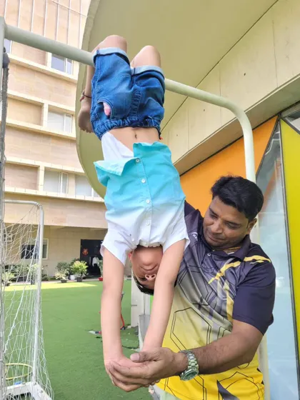 Building upper body strength is an adventure at our camp. With close supervision from our coach, this student masters the monkey bars, learning to trust his strength and coordination in a playful setting.