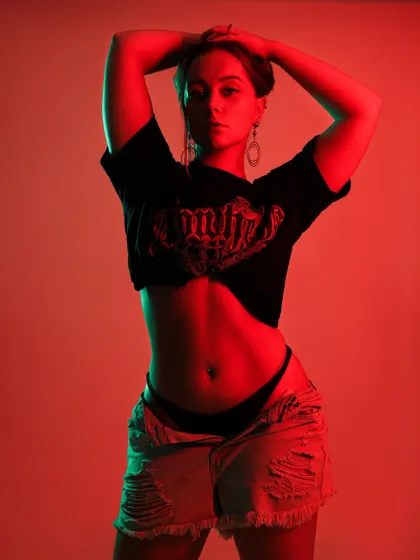 Using colored gels to paint with light, this portrait combines fiery red and cool green tones. This technique creates a modern, edgy vibe perfect for an editorial look.