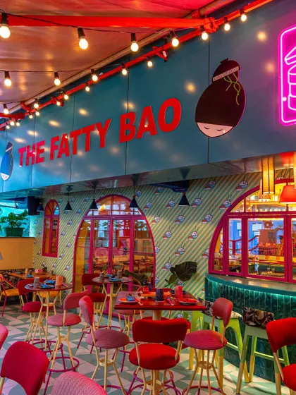 Another wide view of The Fatty Bao, this time focusing on the main branding and the string lights that add a festive feel. This image communicates the brand identity and the lively, casual dining experience.