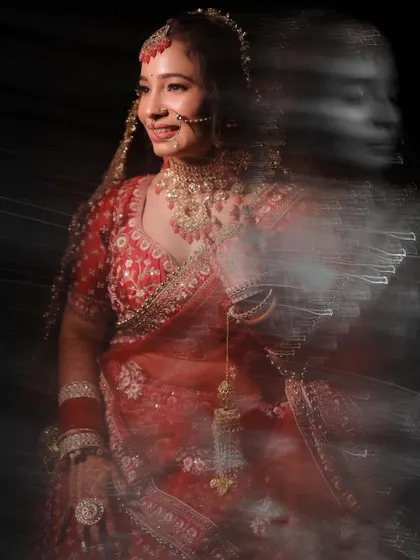 A creative bridal portrait using a slow shutter speed to create a beautiful motion blur effect, capturing the bride's joyful movement.