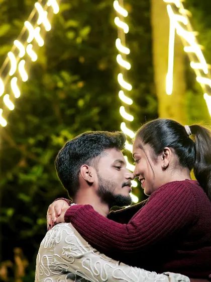 A change of outfits for a night shoot. The warm tones of their sweaters and the romantic lighting create a cozy and intimate feel.