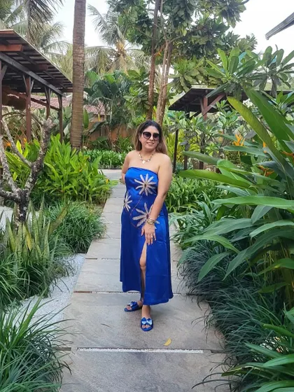 Vacation mode on. This client is wearing a custom blue strapless dress with a thigh-high slit, perfect for a beach holiday.