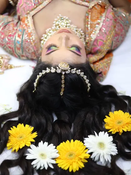 An artistic overhead shot that highlights the hairstyle and the colorful eyeshadow.