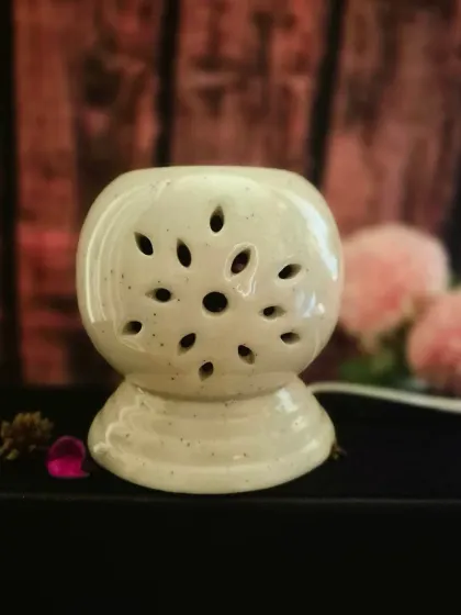 My new Electric Wax Melt Warmer, unlit. Its ceramic design with floral cutouts is beautiful enough to be a decor piece on its own.