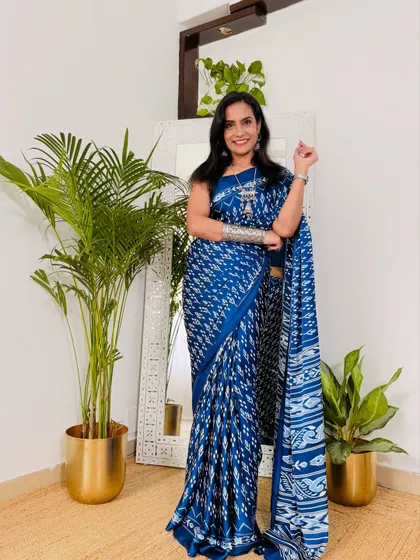 This blue ikat-print satin crepe saree is one of my favorites for work. The color is beautiful, and the print is very stylish. It's a comfortable and affordable find from Myntra.