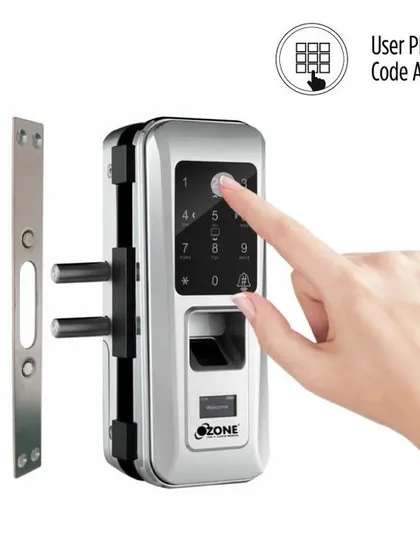 A user entering a PIN code on the glass door lock's keypad. This model includes an anti-theft password feature, allowing you to enter random numbers before or after your actual code to protect it from onlookers.