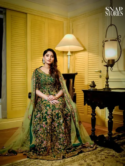 A regal portrait of a woman in a stunning green embroidered gown. We provide fashion-forward portraiture for all your wedding-related events.