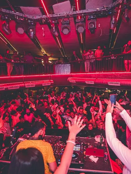 An overhead view of a multi-level club with everyone's hands in the air. I know how to command a large space and keep the energy high all night.