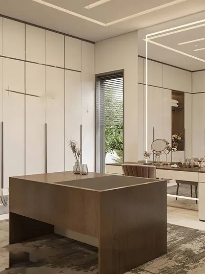 A bright and airy walk-in closet with white, handleless wardrobes and a central wooden island. The unique, minimalist light fixture above the vanity adds an artistic touch.