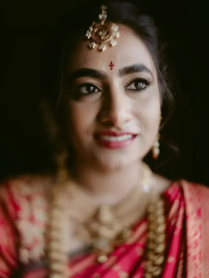 A warm, close-up portrait of a beautiful bride. The soft focus and her gentle smile make this a very personal and endearing shot.