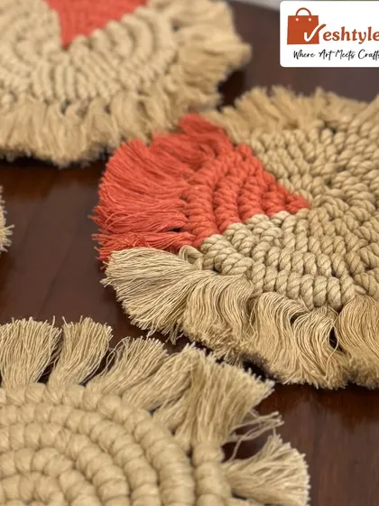 A close-up of the orange and jute macrame coaster. You can see the spiral knotting technique and the soft, fringed edge.