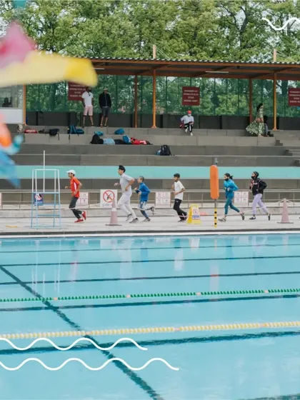 A group of our young swimmers warming up by the poolside. We instill the discipline of proper preparation from an early age to build healthy, lifelong habits.
