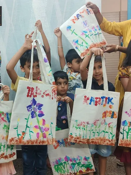 Look at this proud group holding up their custom-designed tote bags! They used vegetable printing to create these beautiful floral patterns, turning a simple bag into a piece of wearable art.
