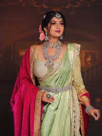 Another view of the 'Peshwe Bai' look, this time focusing on the luxurious layers of jewelry. The diamond and emerald sets, including the belt and maang tikka, are central to this regal portrayal.