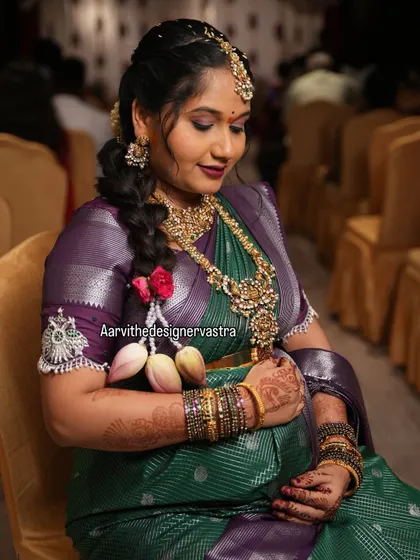 Our beautiful client Parinitha celebrating her baby shower in a custom green and purple silk saree with a specially designed blouse.