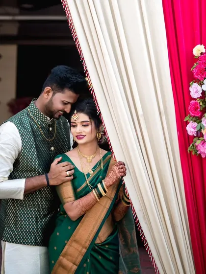 A quiet, romantic portrait of the couple sharing an intimate moment, framed by the soft curtains of the wedding venue.