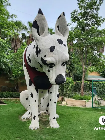 A front-facing view of the large-scale Dalmatian dog sculpture, emphasizing its friendly and inquisitive expression. The piece is hand-painted for a realistic finish.