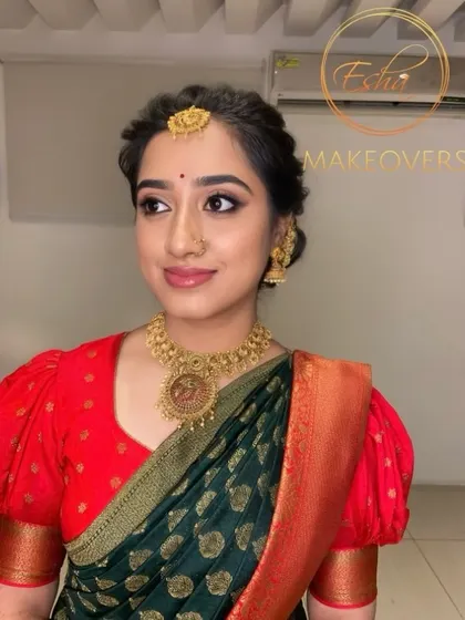 A classic South Indian bridal portrait. The makeup is subtle and clean, with defined eyes and a soft lip, letting the bride's natural beauty shine.