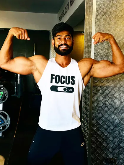 A smile of satisfaction after a great arm workout. A double bicep flex to celebrate the pump.