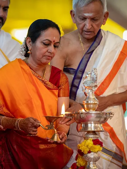 A devotee lights a lamp to commence the Navagraha Homa. This ritual is performed to harmonize the energies of the nine planets and bring balance and well being.
