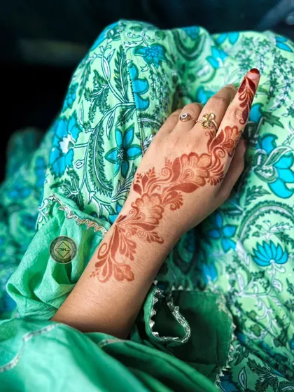 An elegant Arabic-style vine design showing its fresh orange stain.