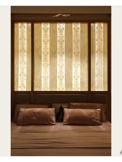 The backlit headboard creates a warm, ambient glow in the evening. The intricate damask pattern on the panels adds a layer of classic elegance to the modern bed frame.