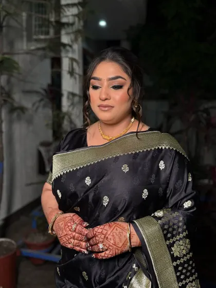 A classic party look featuring a black saree. We created a bold, winged eyeliner and a soft, messy updo to give it a modern and sophisticated feel.
