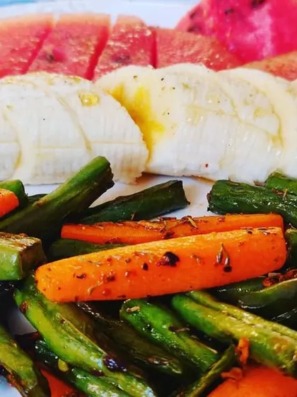 I believe in using fresh ingredients. Here is a simple platter of sautéed carrots and beans with fresh fruit, reflecting my focus on healthy, quality food.