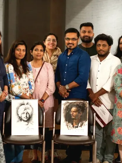 A group photo with the wonderful participants of the Delhi workshop, holding up their completed sketches.