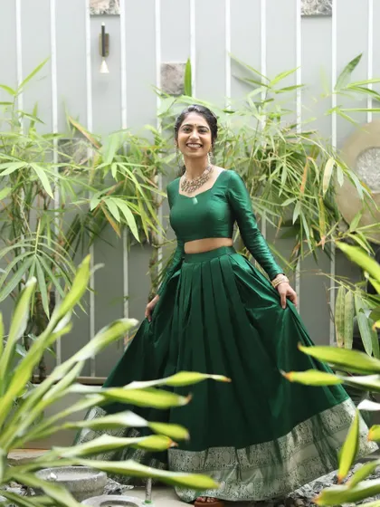 The beautiful Mahima, sister of the bride, ready for a pre-wedding ritual. Her look is fresh and vibrant, with a simple hairstyle and makeup that complements her green outfit.
