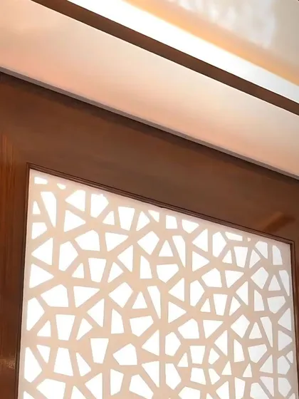 A backlit CNC-cut panel adds a layer of texture and soft, diffused light to this room, all managed through our smart automation system.