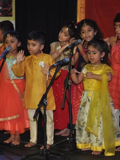 Our little performers getting ready for their moment on stage. We teach them not just the notes, but also the joy of sharing their music with an audience.