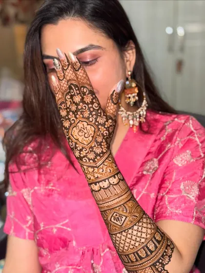 A classic 'peek-a-boo' pose with the beautifully adorned hand. This shot highlights the intricate details of the back-of-hand design.