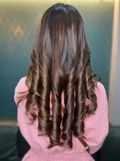Elevate your look with the rich allure of luscious brown hues. These tight, bouncy curls are full of life and dimension.