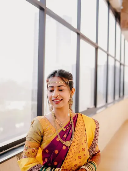 A lovely portrait of another bride by a large window, bathed in beautiful, bright, natural light.