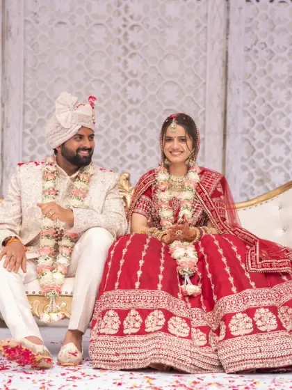 A moment of quiet togetherness for the couple, seated on an elegant sofa after their wedding ceremony. I ensure you have these moments to soak in the joy of your big day.
