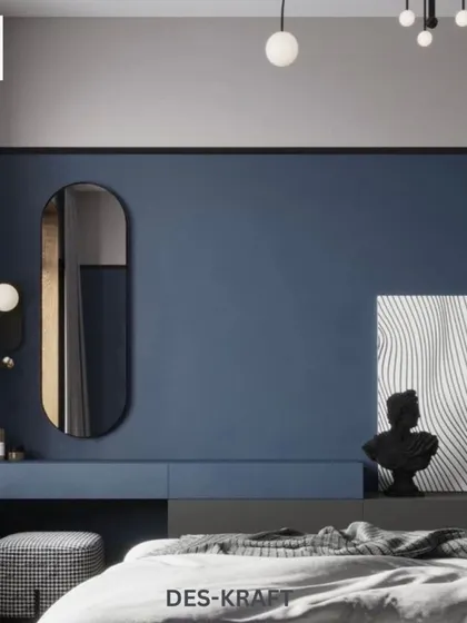 This angle reveals a sleek, built-in vanity area against the blue accent wall, complete with an oval mirror and contemporary decor, proving that bold can also be functional.