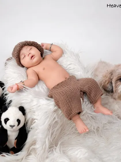 Even the furriest family members are welcome. This sweet newborn portrait includes the family dog, capturing all the love that surrounds your new baby.