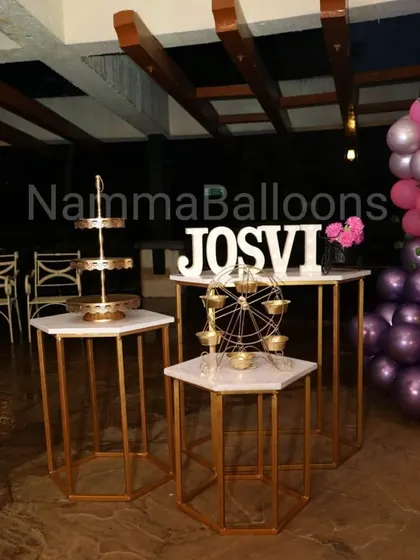 A set of modern hexagonal pedestals in white and gold, perfect for displaying desserts, gifts, or decorative items like this miniature Ferris wheel.