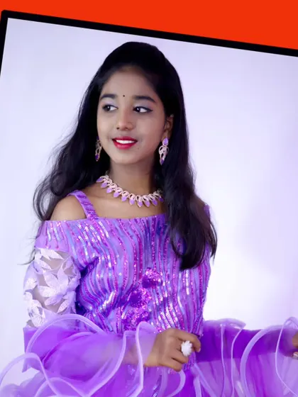 A beautiful portrait of a young model in a purple sequin lehenga, perfect for a festive occasion.