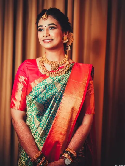 A full-length portrait of the bride in her stunning silk saree, showcasing the complete traditional look.